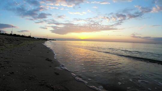 日落时海浪拍打着海滩视频素材模板下载