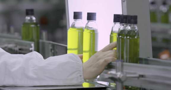 工厂工人操作流水线瓶装产品
