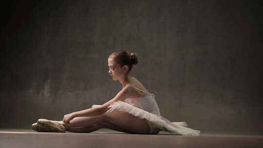 芭蕾舞演员在芭蕾舞室伸展双腿
