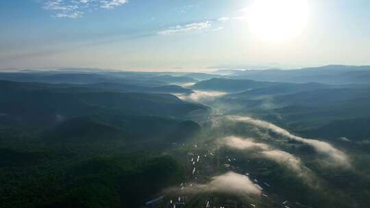 航拍大兴安岭地区大山深处村庄日出云海