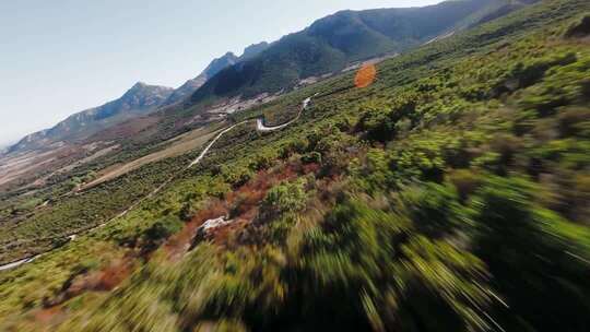 FPV穿越机无人机航拍森林公路山脉蓝天白云