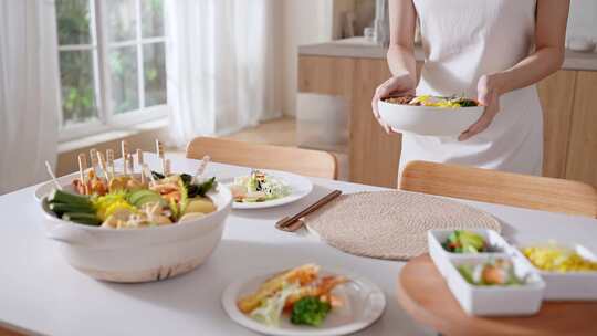 女性端送食物至餐桌