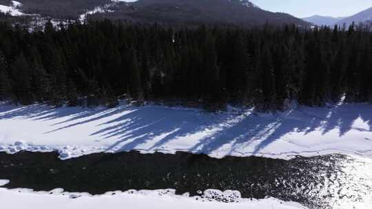 航拍新疆冬季喀纳斯河流晨雾雪山森林雪景