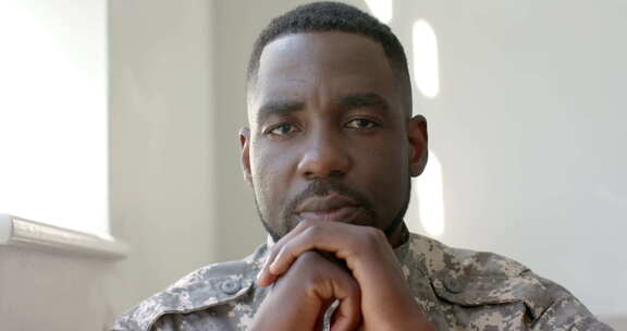 穿着军装的非裔美国士兵在家里显得沉思