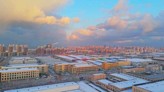 冬季航拍烟台大雪后的城市建筑和晚霞风景