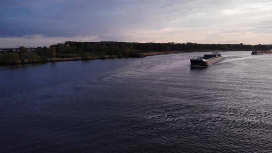 Excelsior航运公司的货船白天在巴伦德雷赫特的河边航行。广角镜头