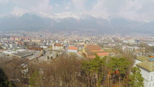 奥地利阿尔卑斯山底部大城市的美丽鸟瞰图，山上的雪