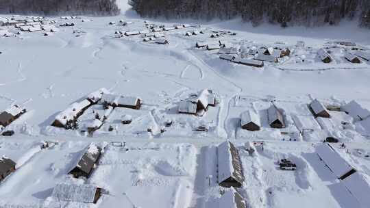 航拍新疆禾木雪景森林雪地小木屋禾木桥雪山