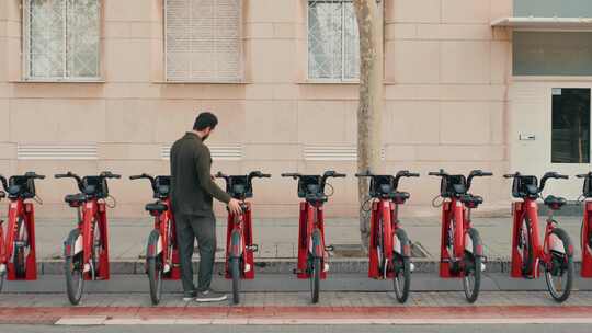 游客在共享停车场乘坐电动脚踏车或自行车旅