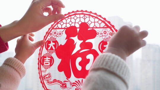 亚洲中国母子春节贴窗花