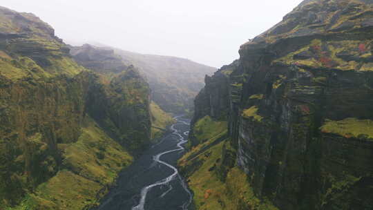 空中上升，流经冰岛崎岖、雾蒙蒙的峡谷。