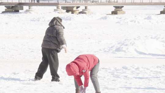 雪地中亲子打雪仗互动玩耍