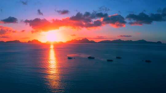 美丽的大山背景下傍晚阳光下海上的帆船