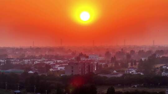 航拍平原夕阳落日房屋风力发电晚霞鸟类