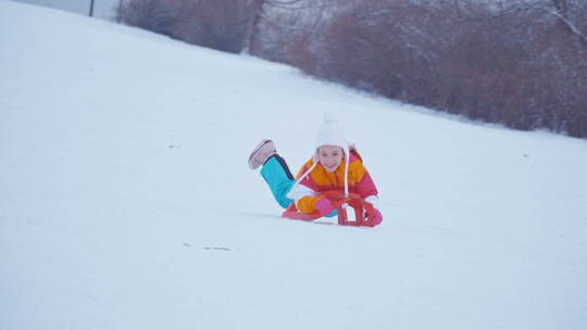 女孩开心的在雪地里滑雪