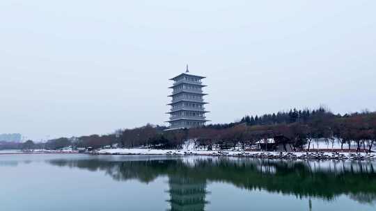 航拍西安中式屋顶与远处塔楼雪景