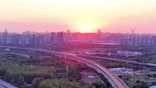 航拍夕阳下行驶的高铁