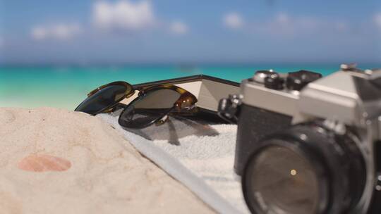 海滩上的墨镜和相机特写镜头