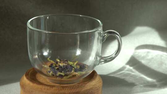 用杯子冲泡安禅蓝茶将沸水倒入装有茶叶的玻