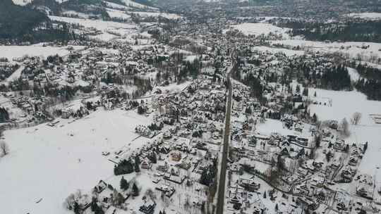 冬天山里村庄的鸟瞰图。雪地上的山村建筑和