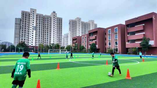 校园足球场青少年踢足球场景