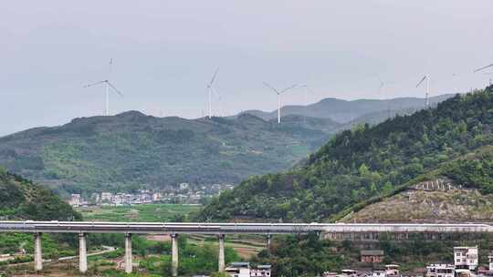 航拍乡村风车风能高铁驶过美景