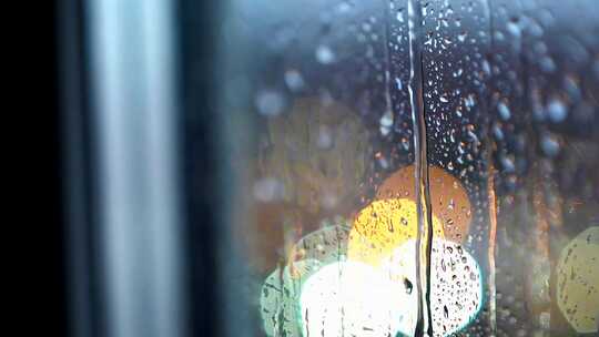 雨天玻璃上的水滴与模糊光影