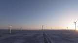 航拍新疆阿勒泰冬季雪原夕阳晚霞戈壁风电场高清在线视频素材下载