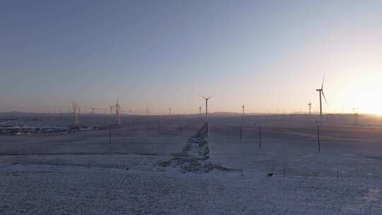 航拍新疆阿勒泰冬季雪原夕阳晚霞戈壁风电场