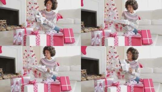 女孩坐在地毯上开心的向镜头展示自己的圣诞礼物高清在线视频素材下载