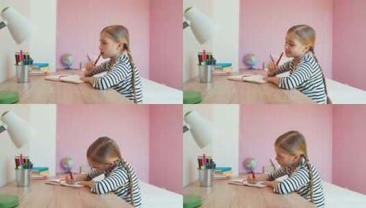 女孩坐在桌前做家庭作业高清在线视频素材下载