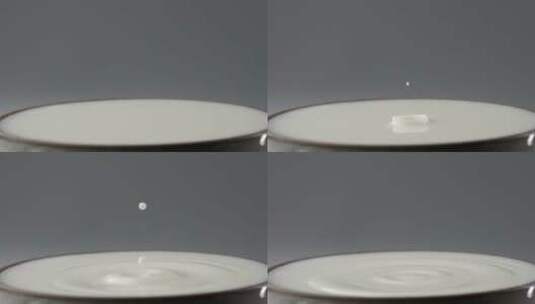 一滴牛奶落到液面的慢镜头拍摄创意视频高清在线视频素材下载