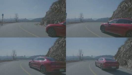 红色新能源电动车在山路转弯 移动跟拍高清在线视频素材下载