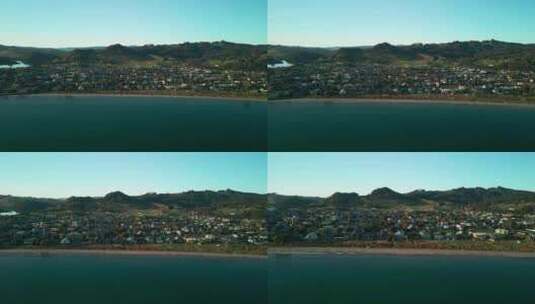 驾驶无人机进入新西兰海滩边的度假小镇高清在线视频素材下载