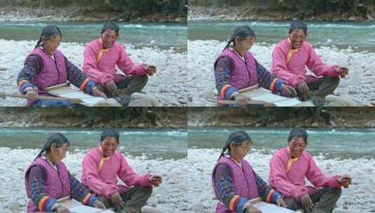 藏族妇女河边纺线织布男子喝酥油茶劳作生活高清在线视频素材下载