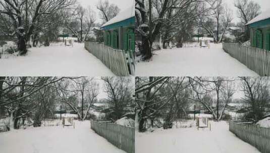 雪中的冬村。雪中的旧村屋和栅栏高清在线视频素材下载