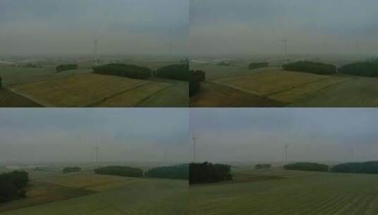 雾气中在田野上的风力发电机高清在线视频素材下载