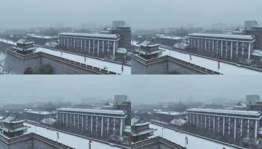 航拍陕西省西安市正在下雪的西安城墙雪景高清在线视频素材下载