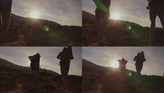 游客在落日的阳光下爬山的剪影高清在线视频素材下载