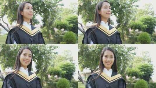 穿着毕业礼服的女生微笑站在树下高清在线视频素材下载