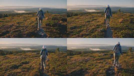 一名背着背包的女旅行者穿过挪威的高地高清在线视频素材下载