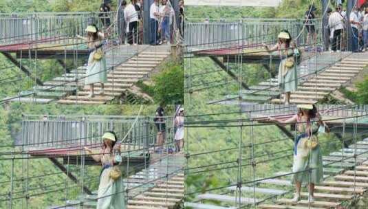 4K升格实拍走网红吊桥的女性高清在线视频素材下载