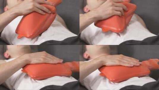 腹部疼痛的病人在胃里用热水袋高清在线视频素材下载