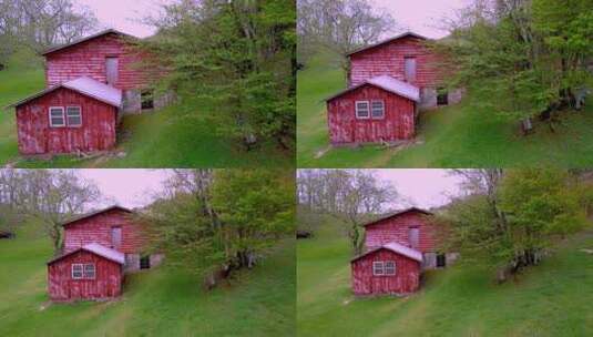 绿色草地上的红色谷仓建筑物高清在线视频素材下载