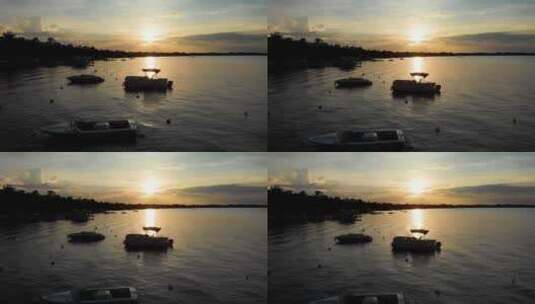 日落湖上船只的剪影高清在线视频素材下载