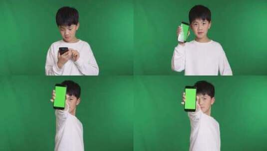 可爱的中国小男孩展示绿屏智能手机高清在线视频素材下载