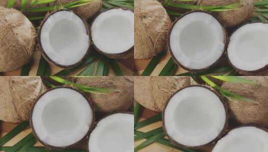 新鲜打开的椰子与椰子，切片和椰叶。高清在线视频素材下载