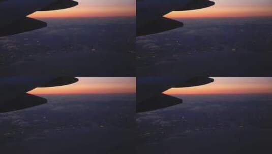 透过飞机窗户拍摄海滨城市日落云海高清在线视频素材下载