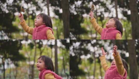 小女孩在公园树林举起一片秋天的树叶高清在线视频素材下载