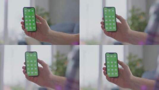 拿绿屏智能手机的男人高清在线视频素材下载